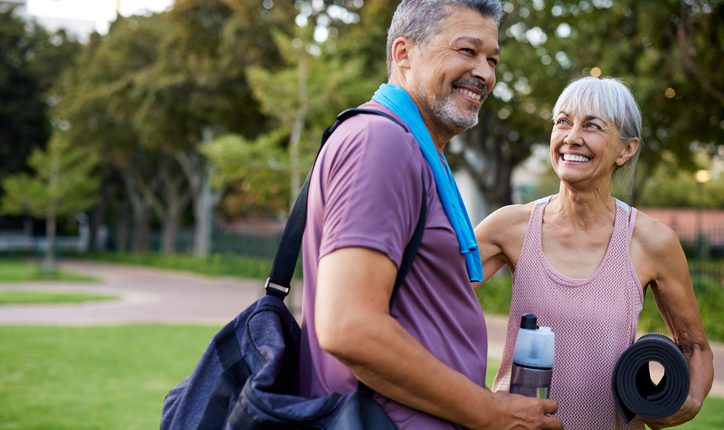 Healthy couple exercising outdoors, promoting back-friendly fitness and injury prevention in Portsmouth, NH.